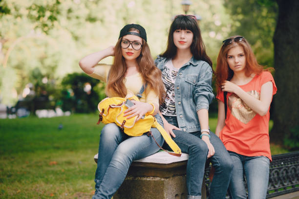 istock three young girls walking in the park 680794594