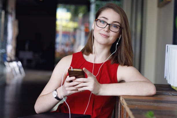 Creative Female Student with textbooks listening to music