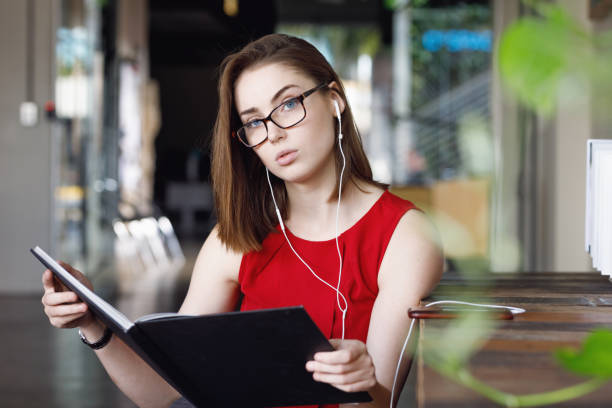 istock Creative Female Student with textbooks listening to music 680794964