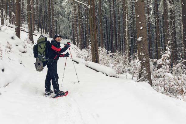 istock Man hiking in winter forest. 680795644