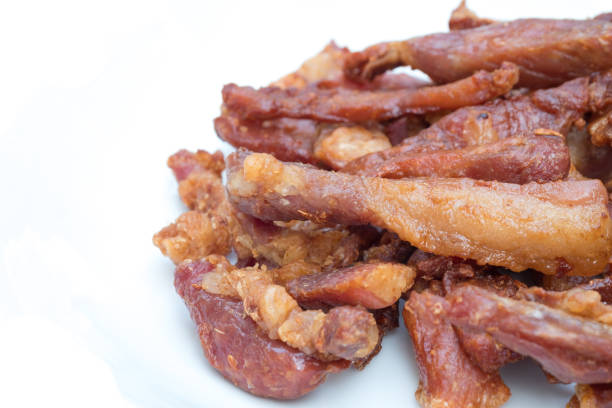 Deep fried pork with garlic and salt on  white ceramic plate.
