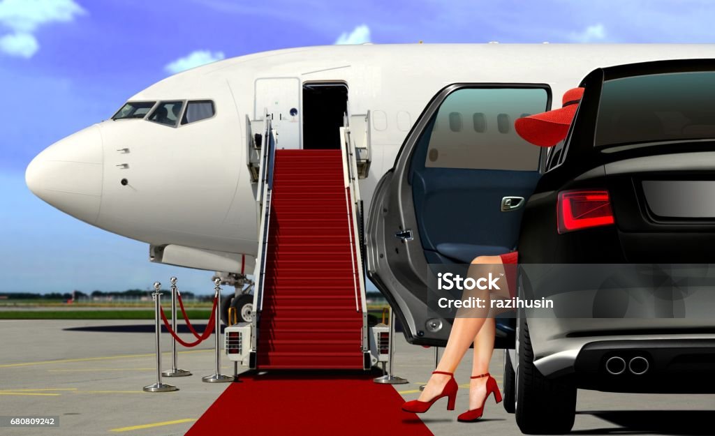 Limousine arrival at the airport with red carpet lady in red arrival with red carpet before boarding an airplane Luxury Stock Photo