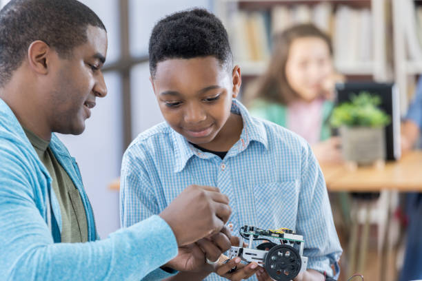 istock Boy builds robot in after school engineering club 680810208