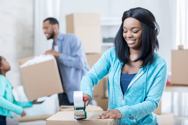 istock Cheerful young woman prepares to move 680810276