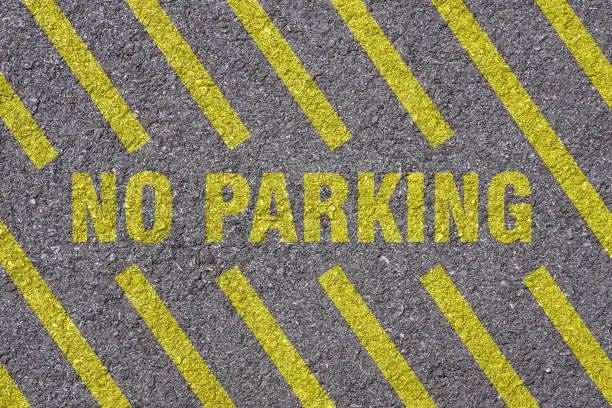 Photo of No parking lettering on street