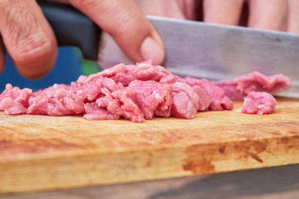 istock Butcher cutting pork meat on kitchen 680833700