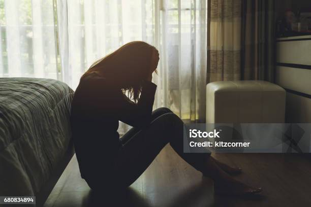 Depressed Woman Sitting In The Dark Bedroom Stock Photo - Download Image Now - Depression - Sadness, Women, Sadness