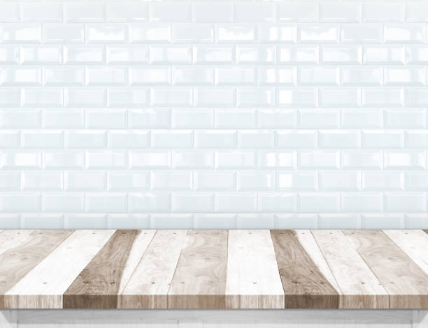 istock Empty wood plank table top with glossy ceramic white tile wall,Mock up for display or montage of product 680834952