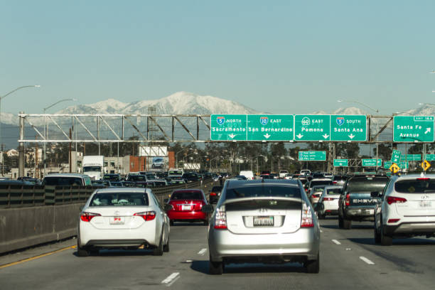 istock Los Angeles traffic jam with snowed capped peak 680844876