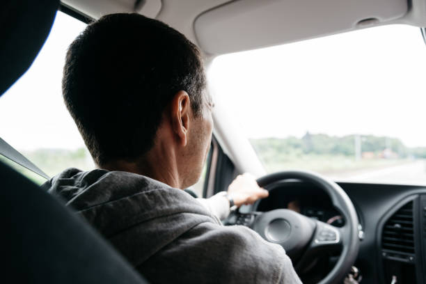 istock Man driving his car on the freeway. Focus on head 680846228