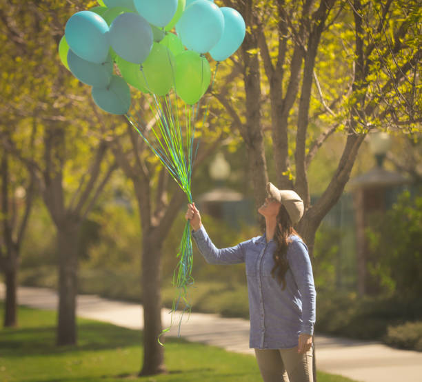 istock Woman holding balloons 680849526
