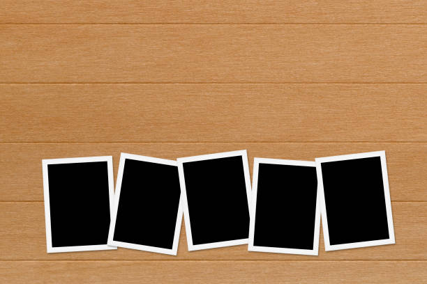 istock Blank photos on Wooden Table Background 680859918