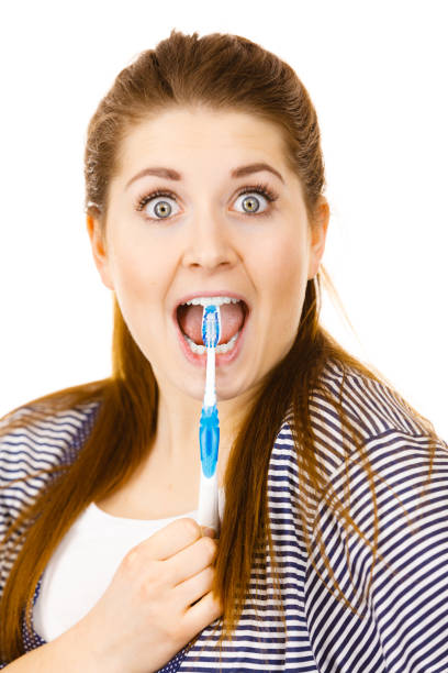 istock Happy woman brushing her teeth with toothbrush 680860000