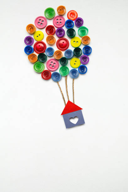 New home. Creative concept photo of a house with air balloons made of paper on white background. paper quilling stock pictures, royalty-free photos & images