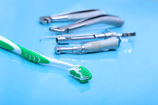 istock dental care toothbrush with dentist tools on mirror background. 680863772