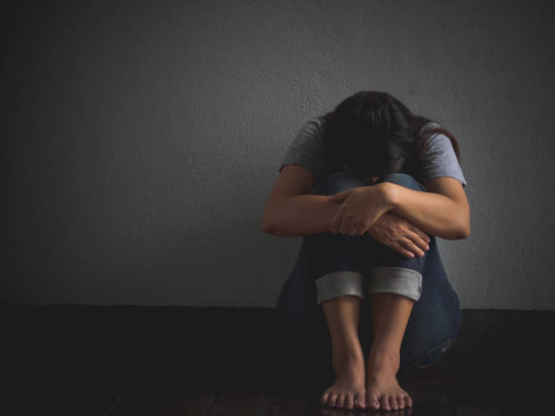 istock sad woman hug her knee and cry. 680864400