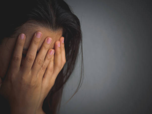 istock sad woman hug her knee and cry. 680864406