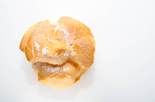 istock Profiteroles stuffed with pastry cream on white desk in cafe 680866252