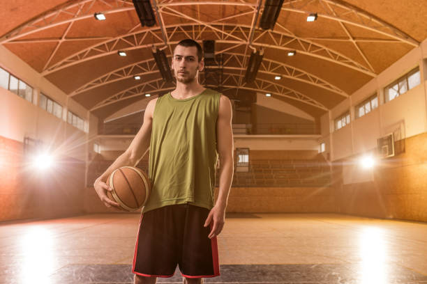 istock Young basketball player with a ball on a court. 680866472