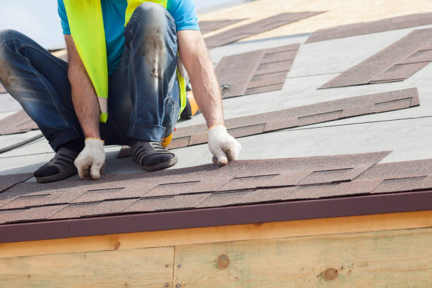 istock Roofer builder worker installing  Asphalt Shingles or Bitumen Tiles on a new house under construction 680866502