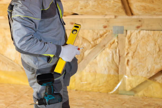 istock Construction mason worker with building level and screwdriver on attic with environmentally friendly and energy efficient thermal insulation rockwool. 680866524