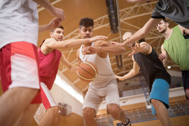 istock Young African American basketball player trying to avoid his opponents on a match. 680868906