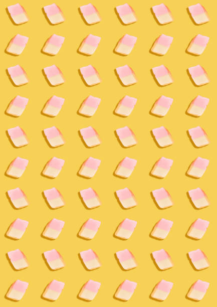 istock white marshmallows on a yellow background. geometric pattern of white marshmallows. top view 680869360