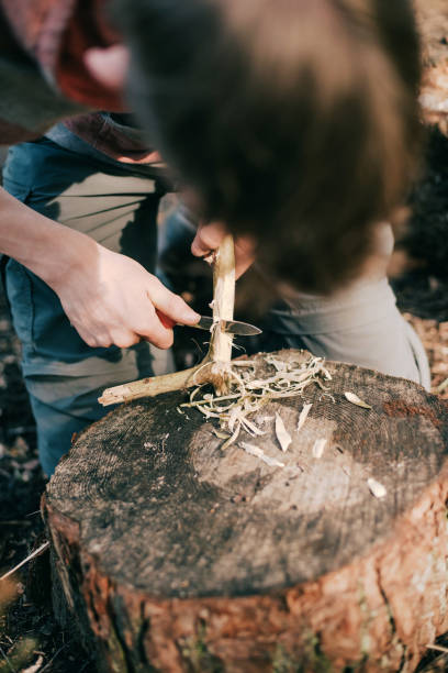 istock Tourist cutting branch to set up a campfire. 680873790