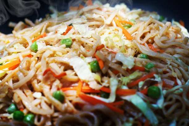 Traditional Delicious Vegetarian Pad Thai, Thai style fried noodles cooking in Wok