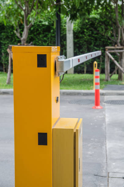 istock Security system for building access - barrier gate stop with toll booth, traffic cones and cctv 680874672
