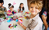 Group of kids painting easter eggs