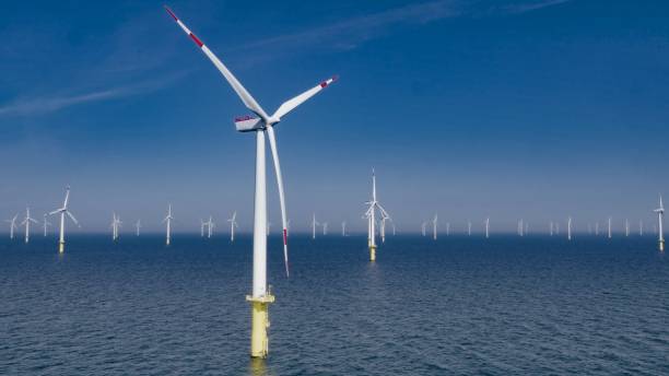 offshore wind farm - horizon over water white green blue imagens e fotografias de stock