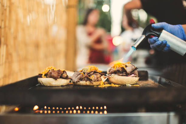 istock Chef using gas torch for cooking burgers 680882108