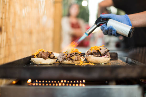 istock Chef using gas torch for cooking burgers 680882162