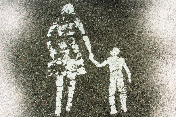 Old painted sign on asphalt, woman with child