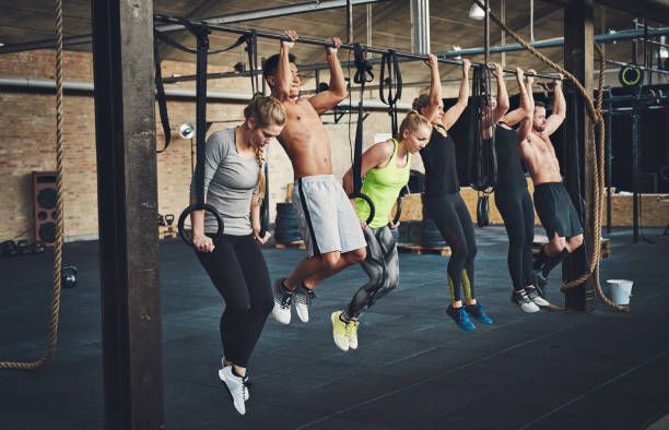 istock Athletes doing pull ups on in fitness room 680886702