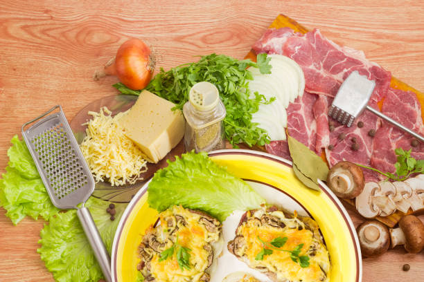 istock Baked pork chops with cheese and ingredients for their preparation 680887896