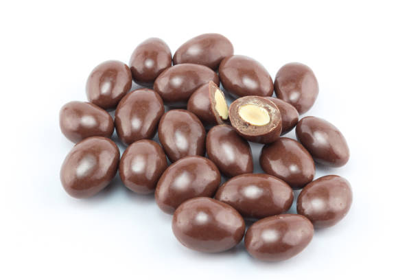istock Chocolate covered nut balls in a group isolated on white background - closeup 680898592