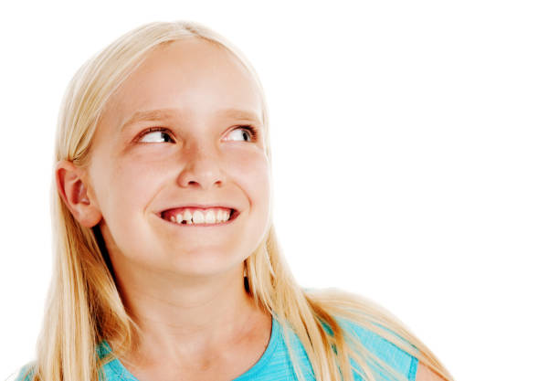 istock Cute little blonde girl glances sideways, smiling brightly 680898792