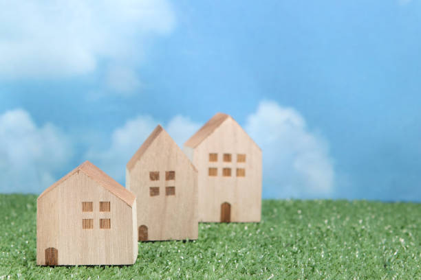 istock Houses on green grass over blue sky and clouds. 680898832