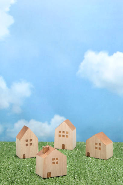 istock Houses on green grass over blue sky and clouds. 680898848