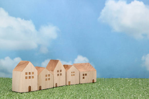 istock Houses on green grass over blue sky and clouds. 680898864
