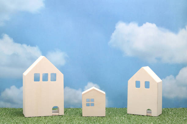 istock Houses on green grass over blue sky and clouds. 680898872