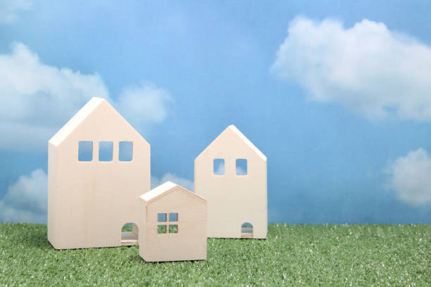istock Houses on green grass over blue sky and clouds. 680898880