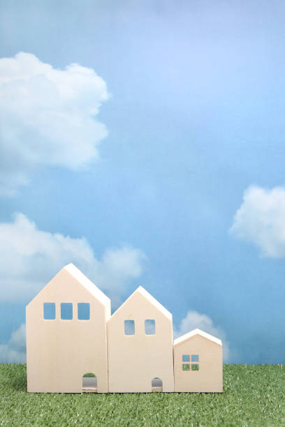 istock Houses on green grass over blue sky and clouds. 680898882