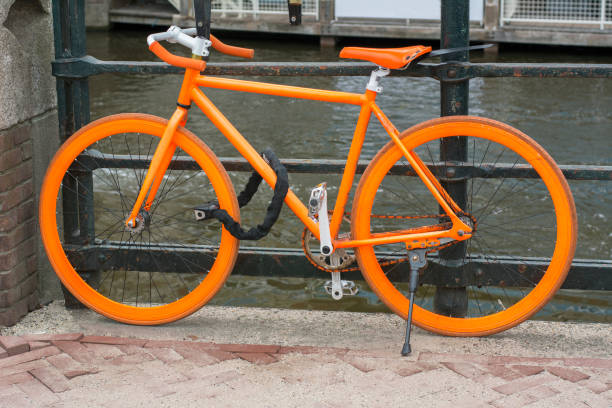 istock Orange bike is standing on pavement in Amsterdam 680898952