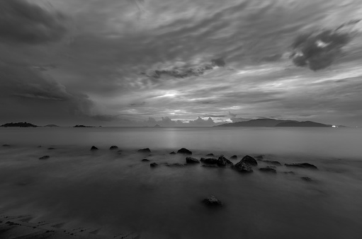 A moody black and white morning sky over Nha Trang bay Vietnam just before sunrise.