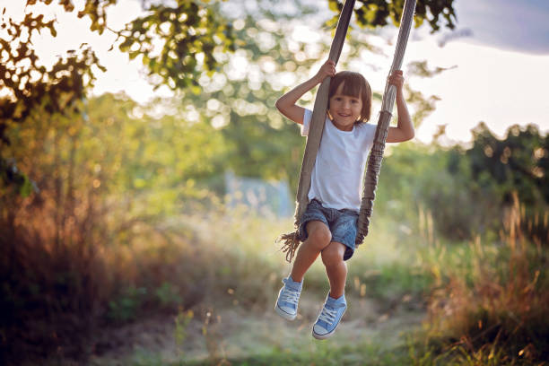 istock Cute child, boy, having fun on a swing in the backyard on sunset 680902886