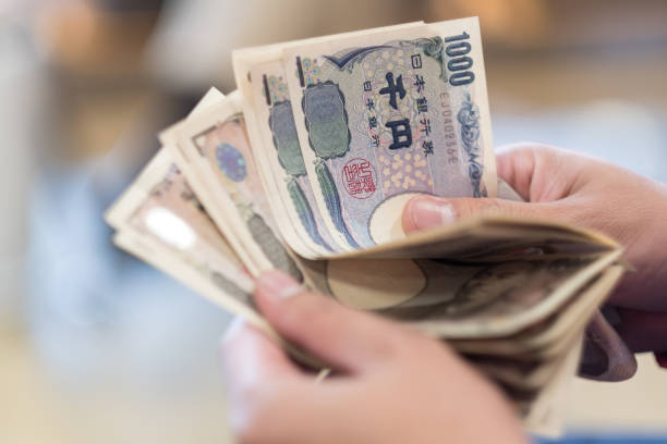 Japan currency notes on hand stock photo