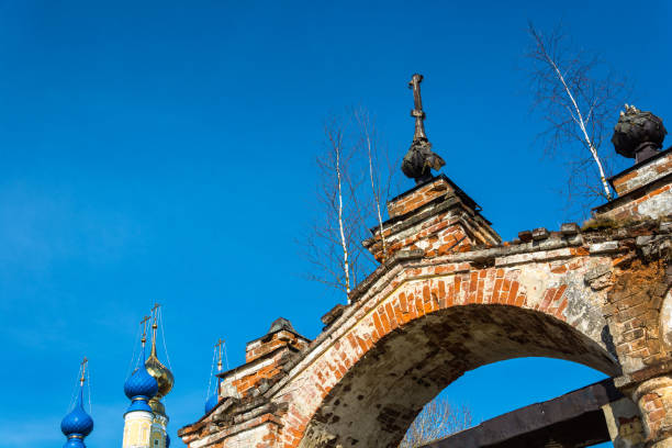 istock Old Church archway, overgrown with birches, Russia. 680916292